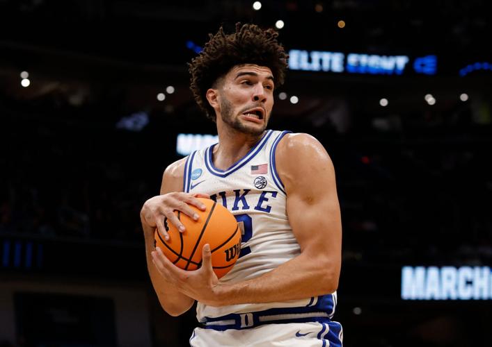 Mar 29, 2026; Washington, DC, USA; Duke Blue Devils forward Cameron Boozer (12) rebounds the ball against the UConn Huskies in the first half during an Elite Eight game of the East Regional of the men's 2026 NCAA Tournament at Capital One Arena. Mandatory