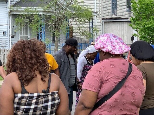 Pastor Tim Newkirk leads a prayer circle with survivors of the Tops massacre on Riley Street, just outside the store on May 14 (copy)