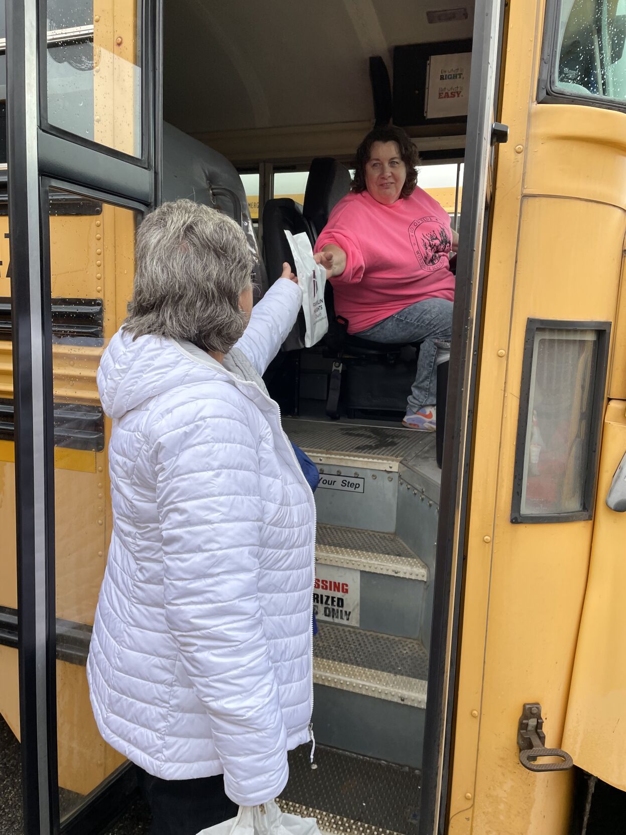 A volunteer hands an appreciation bag to Windy Gap school bus driver Regina Saunders for National School Bus Drivers Appreciation Day..jpg