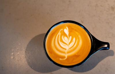 A latte sits on a counter at Press Coffee in Phoenix on July 16, 2026.