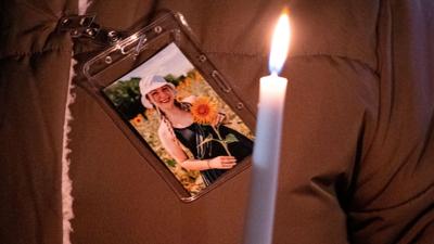 A photo of Abby Zwerner is pinned to a coat during a vigil for Abby Zwerner, the teacher shot by a 6-year-old student at Richneck Elementary, in front of the Newport News Public Schools Administration Building in January. She made her first public appea...