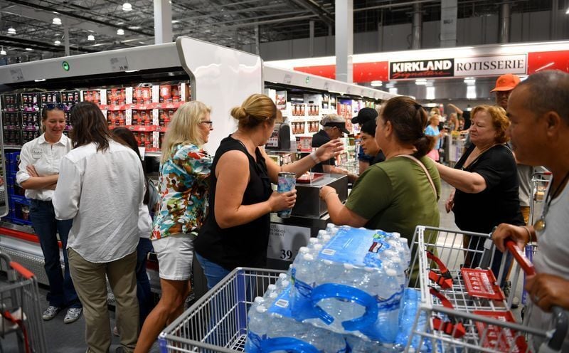 Costco shoppers scramble for free sample of Phillips Foods Lobster Meat during the grand opening of a new store in North Port, Florida.