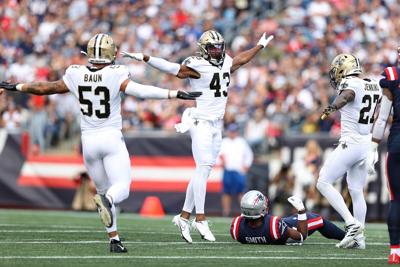 Zack Baun #53, Marcus Williams #43 and Malcolm Jenkins #27 of the New Orleans Saints react after a defensive play against the New England Patriots during the game at Gillette Stadium on Sept. 26, 2021, in Foxborough, Massachusetts.