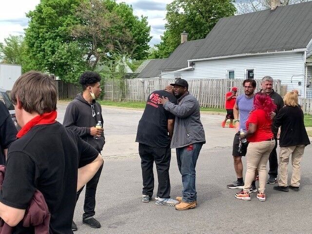 Pastor Tim Newkirk consoles a Tops employee minutes after the massacre on May 14