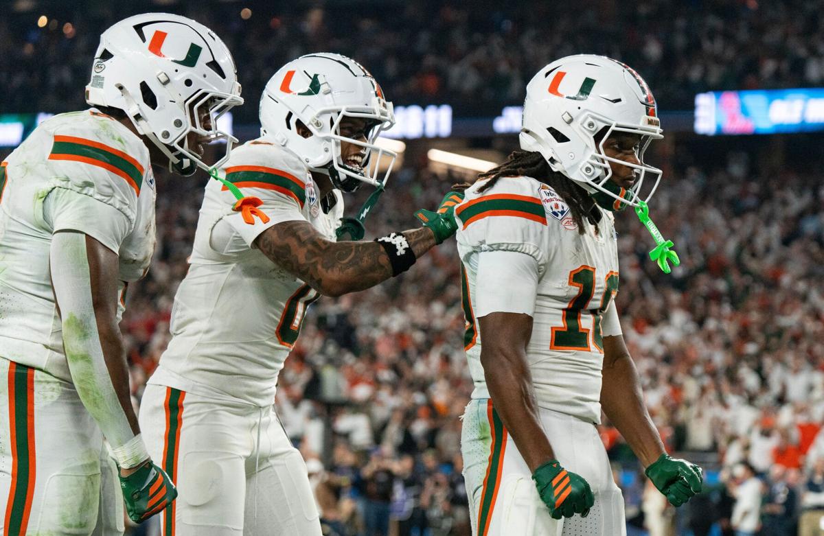 Miami Hurricanes wide receiver Keelan Marion (0) pats Malachi Toney (10) on the back after his touchdown during the CFP Fiesta Bowl at the State Farm Stadium, in Glendale, Ariz., on Thursday, Jan. 8, 2026. (copy)