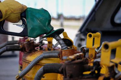 A member of D.H. French Construction fills up cans with Diesel at a 7-Eleven in Oklahoma City, on Thursday, May 7, 2026.