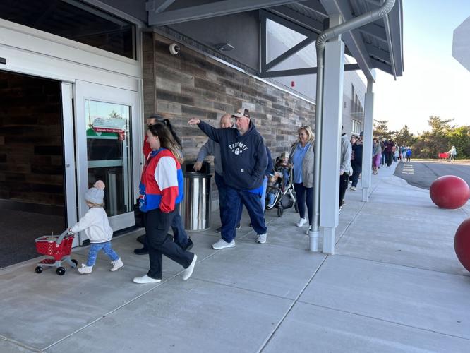 Shoppers line up before the grand opening of the new Outer Banks Target on Sunday, April 2, 2023. The siding along the front of the building is made from reclaimed local driftwood.