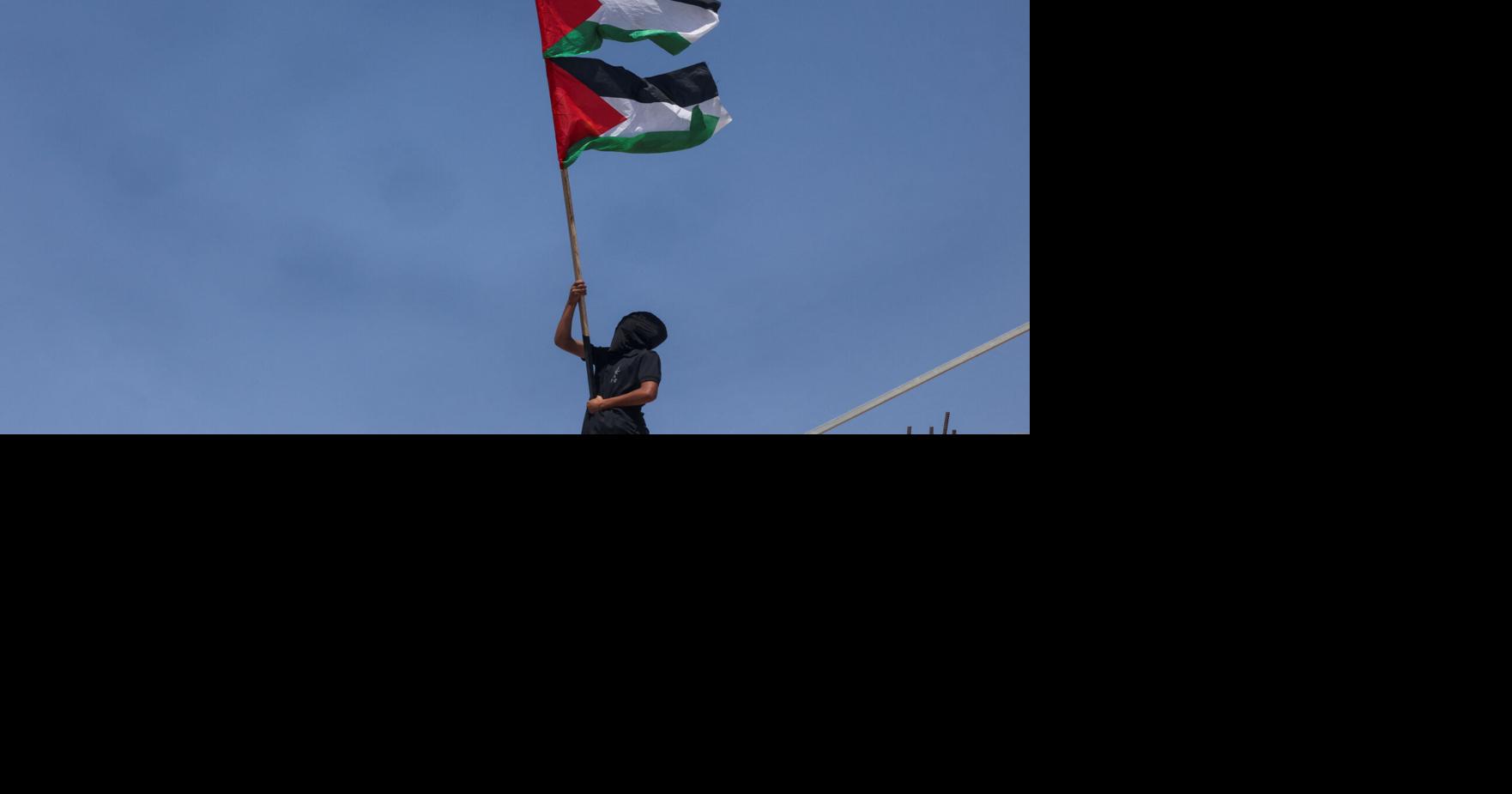 Funeral procession for two Palestinians killed during a militant settlers' attack on their village, in Al-Mughayyir