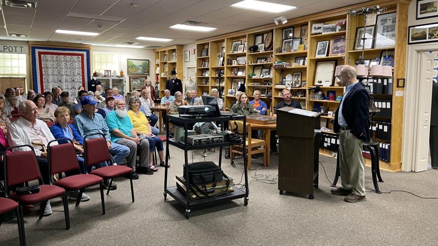 Doss speaking to audience