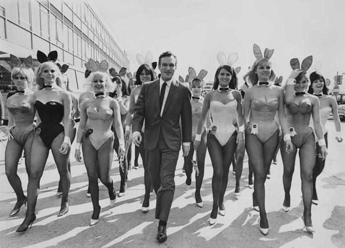 Hugh Hefner arrives at London Airport from Chicago with an entourage of Playboy Bunnies on June 26, 1966, for the opening of the London Playboy Club.