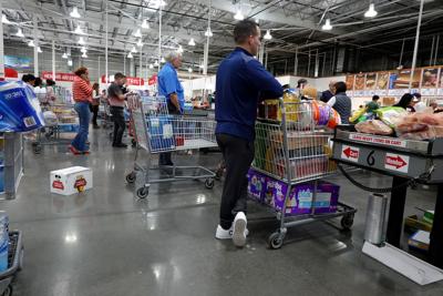 Customers wait in the checkout line at a Costco Wholesale store on Dec. 15, 2023, in Miami.