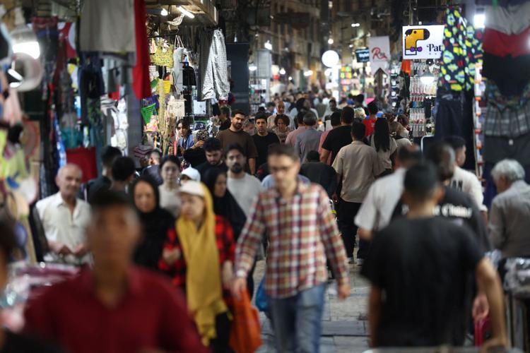 People walk in the Grand Bazaar, in Tehran