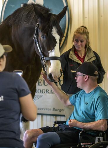 Iraq War veteran Jason Ehrhart gets acquainted with Ivan. Jason rides at Healing Strides two or three times a week..jpg