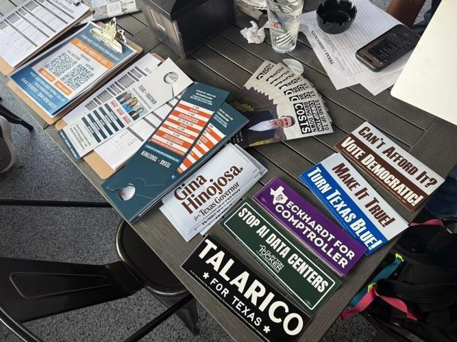 Bumper stickers, pamphlets and voting information is seen at a table during a watch party for Texas Senate Democratic nominee James Talarico's town hall with CNN on Oct. 14 at Mikey's Pizza and Shots in Harlingen, Texas.