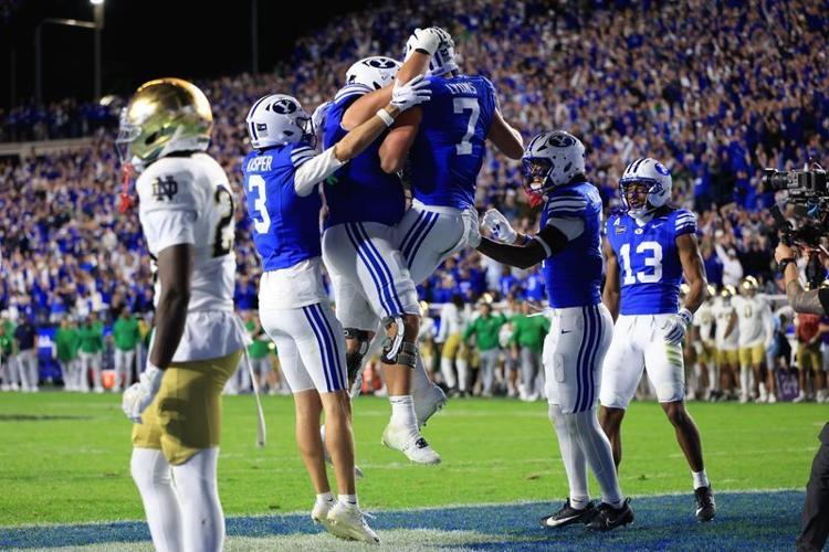 BYU tight end Walker Lyons (7) celebrates with teammates after scoring a touchdown against Notre Dame during the second half at LaVell Edwards Stadium on Oct. 17, 2026.