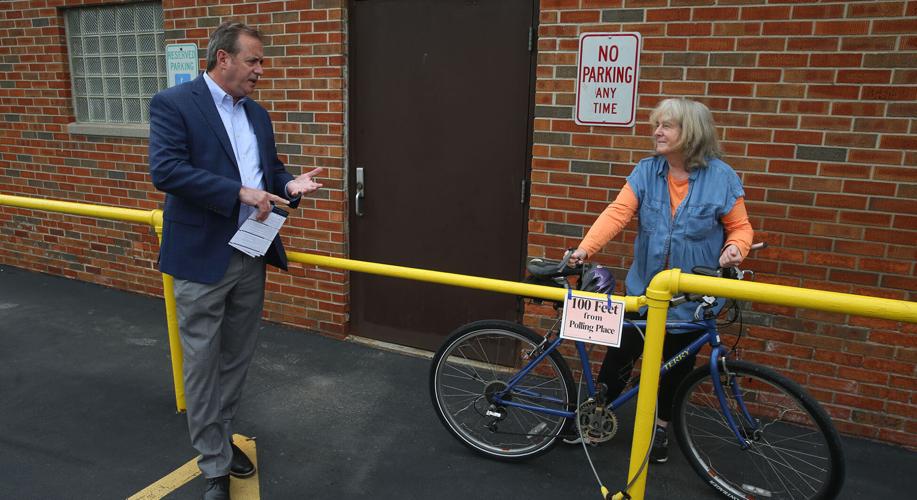 John Garcia talks with Kitty Grace as she goes to vote on primary day