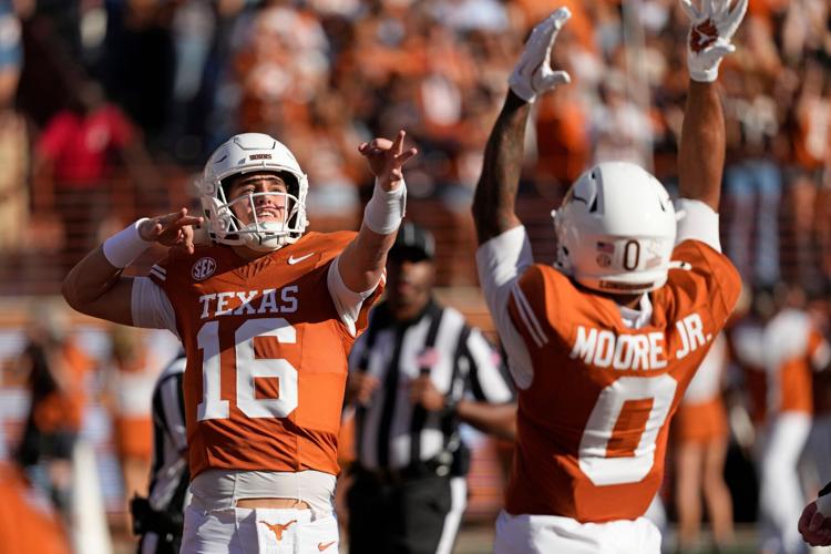 Texas Longhorns quarterback Arch Manning (16) reacts after throwing a touchdown pass in the first half against the Arkansas Razorbacks at Darrell K Royal-Texas Memorial Stadium.