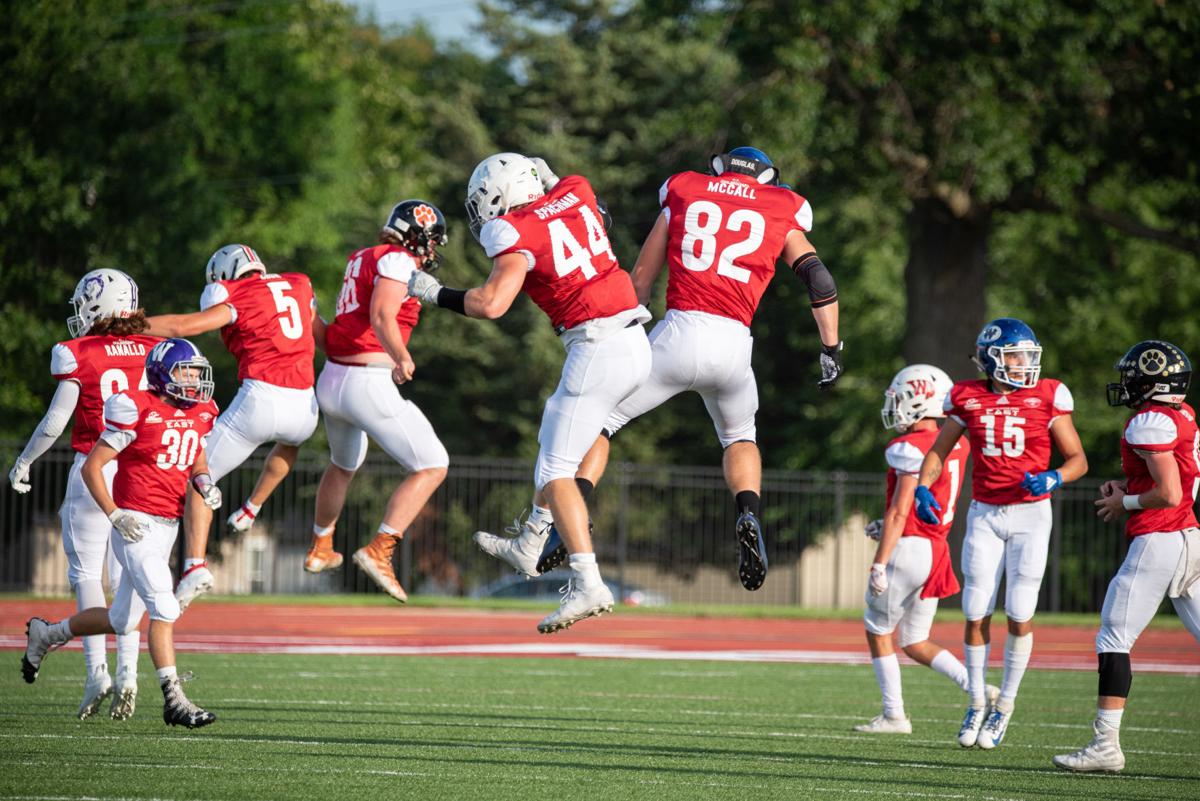 Reid Spachman (44) and Drake McCall (82) celebrate after Kamble Haverkamp intercepted the ball.