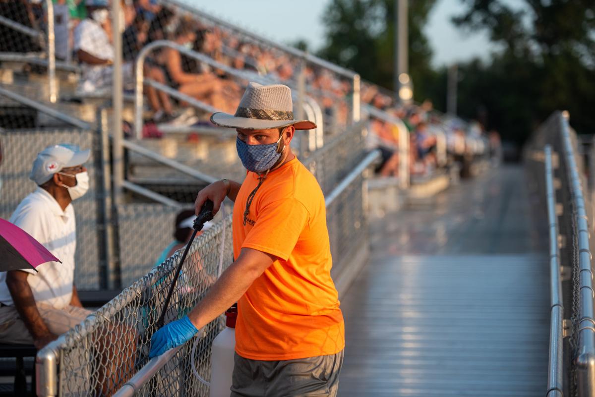 The hand rails of the bleachers at Hummer Sports Park are sanitized during the second quarter of the Kansas Shrine Bowl.