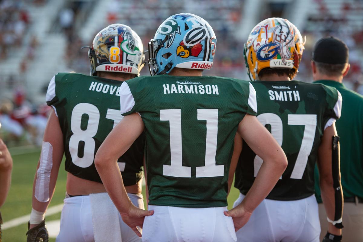 Garrett Harrison (11) stands on the sideline with Tyce Hoover (81) and Phoenix Smith (27).