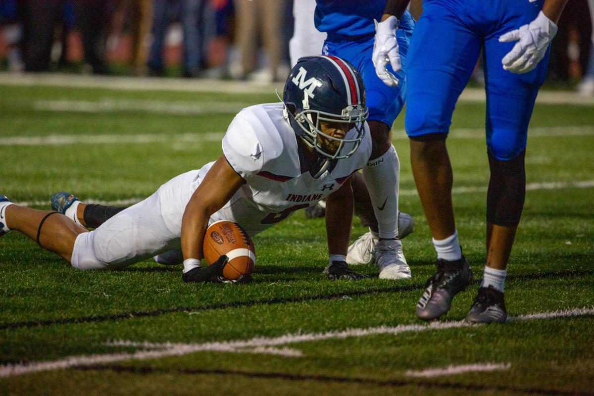 Running back Vincent Smith, junior, hesitates before standing up after defending the ball. Manhattan High Indians went head to head against the Junction City Bluejays on Friday night at Al Simpler Stadium with a final score of Junction City 36, Manhattan 29.