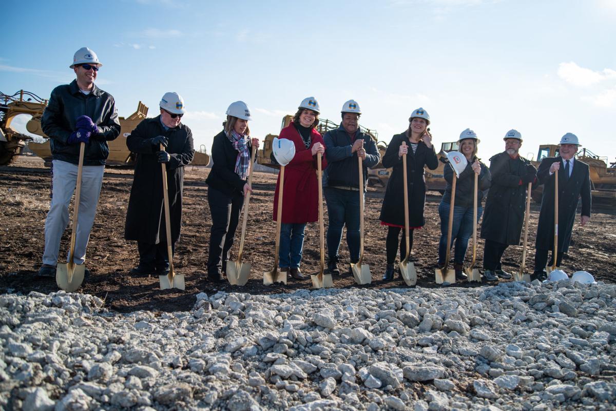 From left, Assistant Superintendent Eric Reid, Darell Edie, Board President Karla Hagemeister, Kristin Brighton, Jurdene Coleman, Katrina Lewison, Brandy Santos, Curt Herrman and Superintendent Marvin Wade dig their shovels into the ground at the groundbreaking of Oliver Brown Elementary School.
