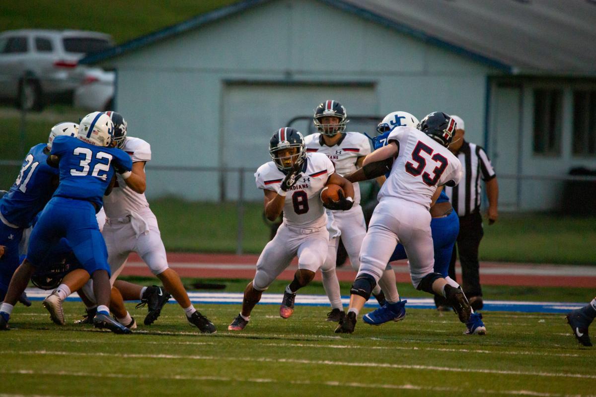 Running back Vincent Smith, junior, maneuvers through to find an opening. Manhattan High Indians went head to head against the Junction City Bluejays on Friday night at Al Simpler Stadium with a final score of Junction City 36, Manhattan 29.