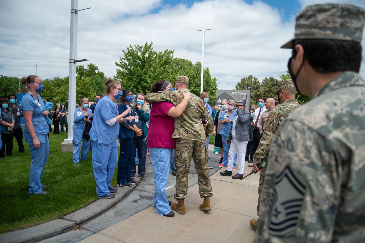 Senior Master Sergeant Wally Brannen hugs Melanie Hastert outside of Ascension Via Christi Hospital after the National GuardÕs 190th Air Refueling Wing flew over the hospital on Tuesday. The mission was titled Operation Kansas Strong and was a salute to healthcare and frontline workers affected during the coronavirus pandemic.