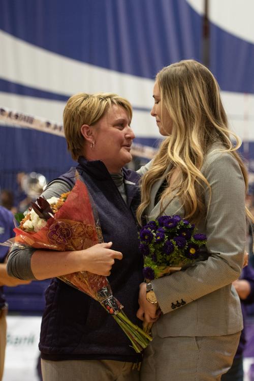 K-State head coach shares a moment with Makenzie Holcomb, senior manager and former middle blocker, during senior night