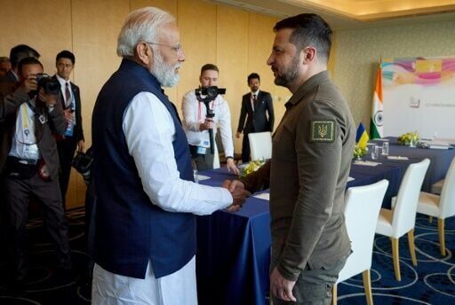 This handout photograph taken and released by the Ukrainian Presidential Press Service on May 20, 2023, shows Ukraine's President Volodymyr Zelensky meeting India's Prime Minister Narendra Modi in Japan