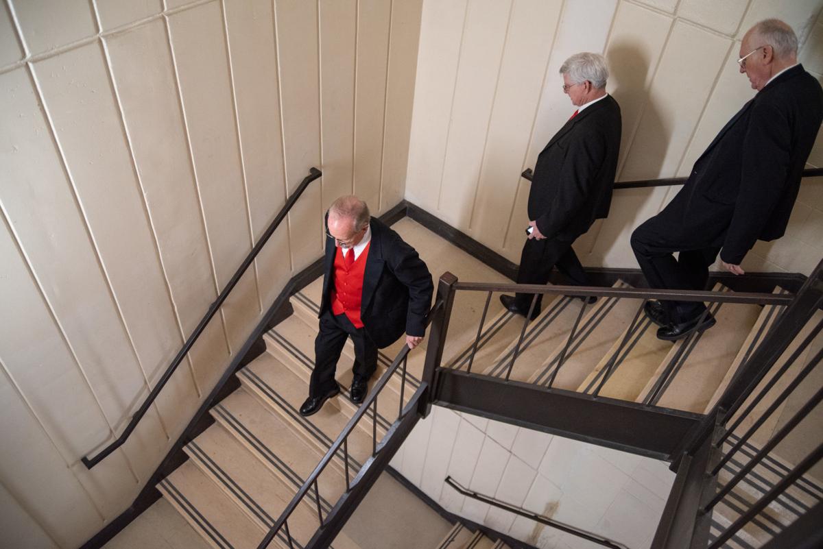 From left, Ken Garwick, Steve McKinzie and Leonard Purvis walk down the stairs of the Carl R. Ice College of Engineering building on K-StateÕs campus after not being able to find their next Singing Valentine recipient.