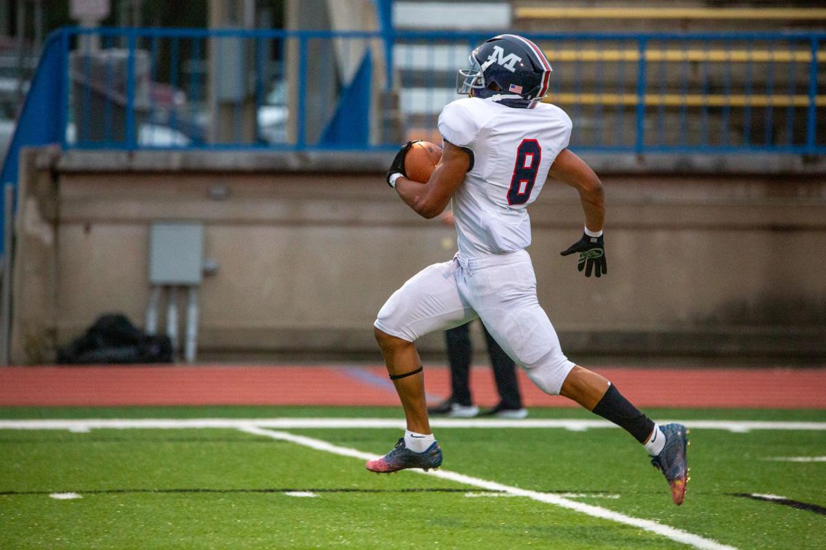 Running back Vincent Smith, junior, strides forward and relieves a touchdown. Manhattan High Indians went head to head against the Junction City Bluejays on Friday night at Al Simpler Stadium with a final score of Junction City 36, Manhattan 29.