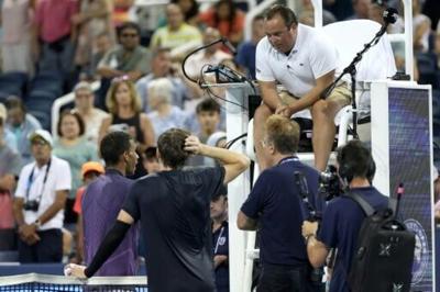 Chair umpire Greg Allensworth explains a controversial match-ending point to Canada's Felix Auger-Aliassime, lower left, and Britain's Jack Draper, who won to reach the ATP Cincinnati Open quarter-finals