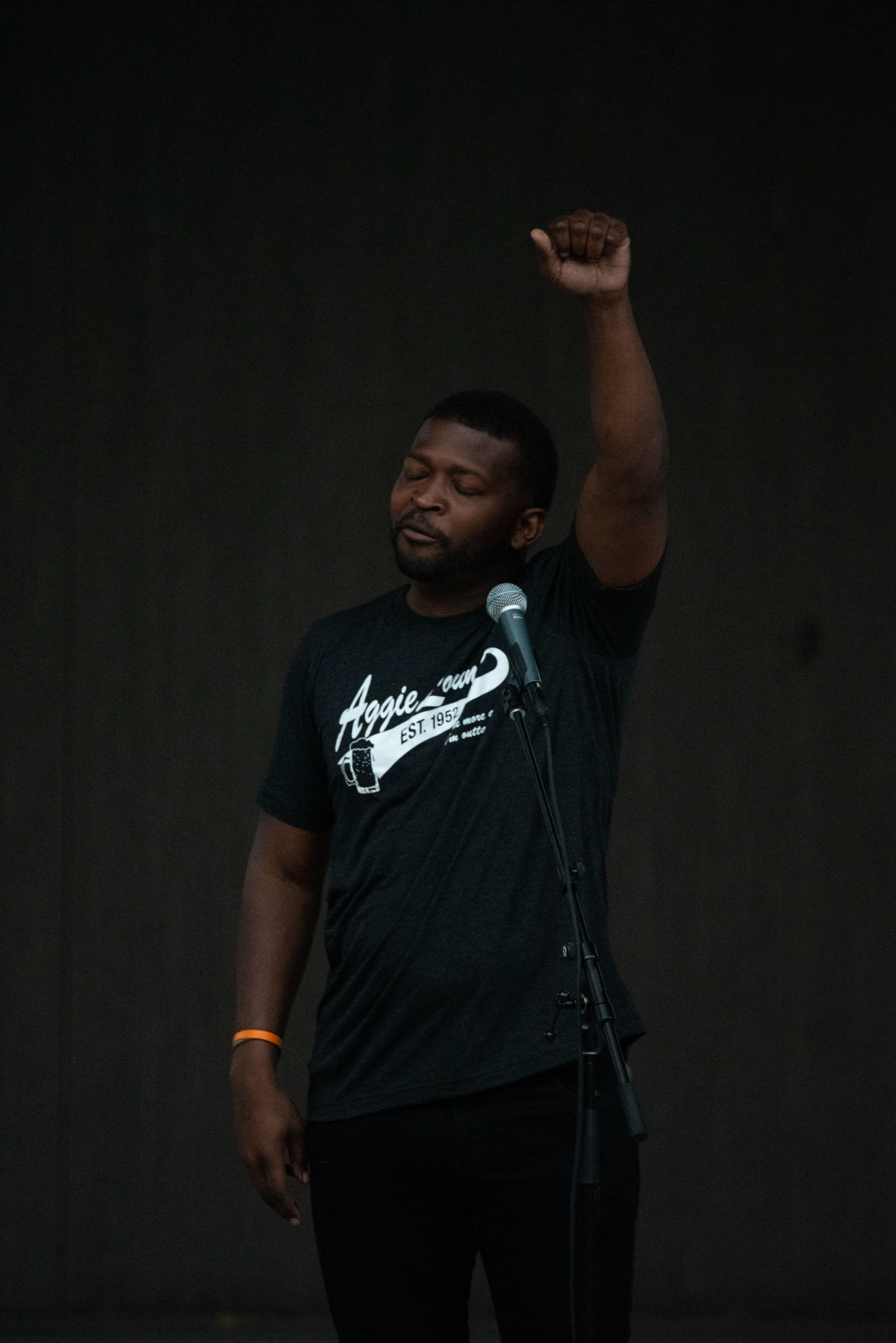 Tory Harris raises his fist while speaking on stage at Wefald Pavilion in City Park before the Flashlight Vigil on Friday. ÒI tell you she (Jaynae Cole) played the song Glory and I donÕt know if your fist was up. How many peopleÕs fist was up? ThatÕs a five minute song, in around two minutes and thirty seconds seconds, what did you feel in that arm?Ó asked Harris. ÒWhatever you felt in that arm, for two minutes and thirty seconds, it was a five minute song and in my head I told myself Tory keep it up. Keep it up! This is all you gotta do right now is keep this arm up. But it takes a little bit more than thatÉ you have to say enough is enough. You have to have that strength to turn around and say enough is enough. Like Mrs. Teresa said, we can be angry but it wonÕt help win anybodyÕs hearts,Ó he added.
