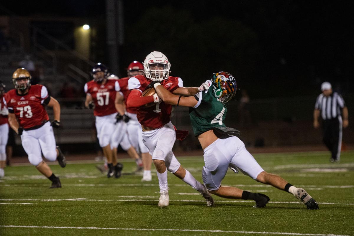 Taybor Vetter (1) stiff arms Scotti Easter (4) after catching a pass for a first down during the third quarter.