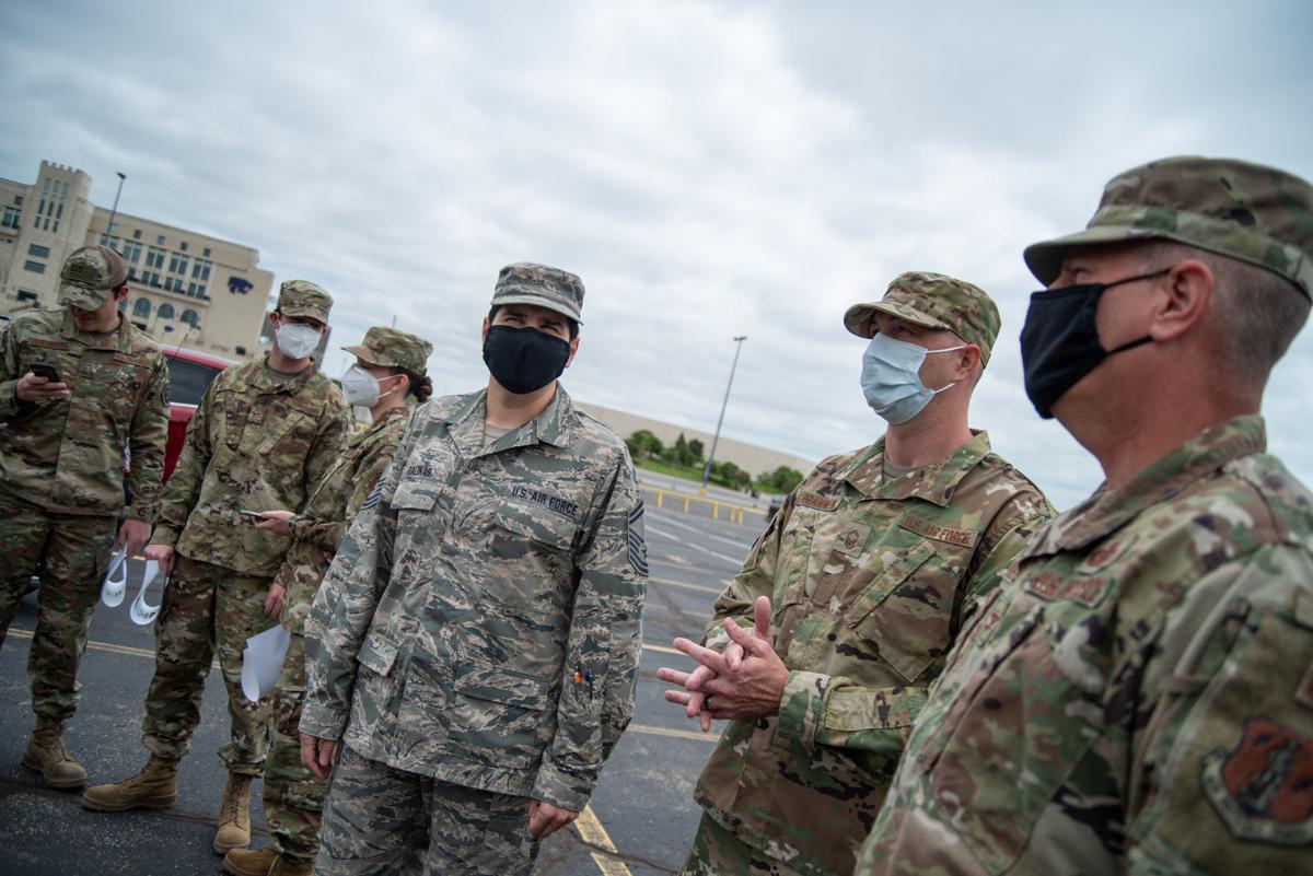 From right, Vice Wing Commander Colonel James Wehrli, Senior Master Sergeant Wally Brannen, David Salinas, Taylor Stevens, Kyler Milligan and Braden Johanning stand across from Ascension Via Christi Hospital before the National GuardÕs 190th Air Refueling Wing flies over on Tuesday.