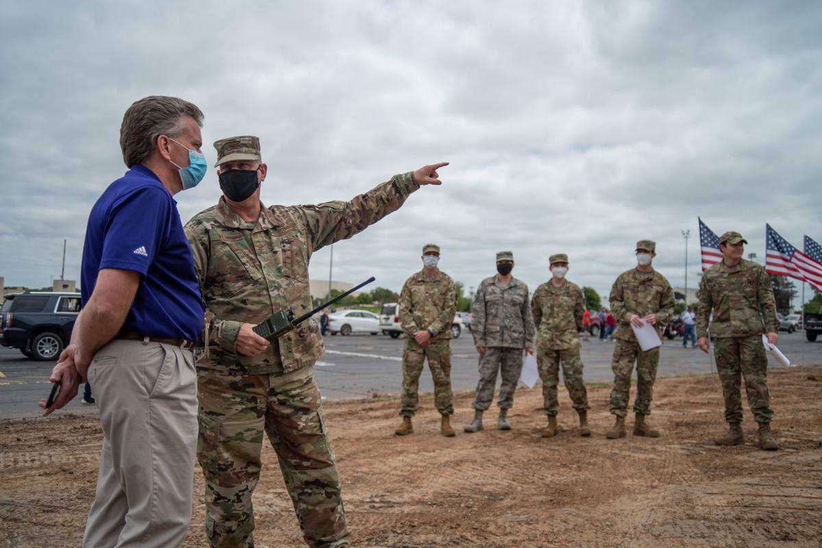 Vice Wing Commander Colonel tells Bob Coppel, President of ManhattanÕs Ascension Via Christi Hospital, the route of the National GuardÕs 190th Air Refueling Wing that is scheduled to fly over the hospital at 1:13 p.m. on Tuesday.