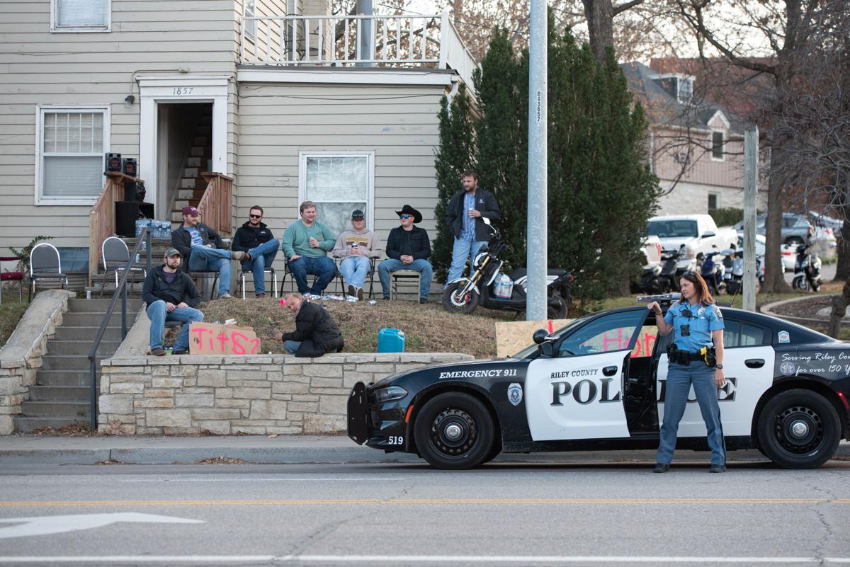 Officer Jamie Dickson gets our of her patrol car at 1857 Anderson Avenue to notify the men sitting outside that they need to keep the alcohol on their property and off of the sidewalk. Dickson also told the men that the “Tits?” sign is legal to have, but there was an anonymous complaint called in from someone who drove by. Dickson told the men that the “U Honk, We Drink” sign could make them liable if an accident occurs because of someone taking their eyes off of the road. “We’re just guys being dudes,” one of the men said.