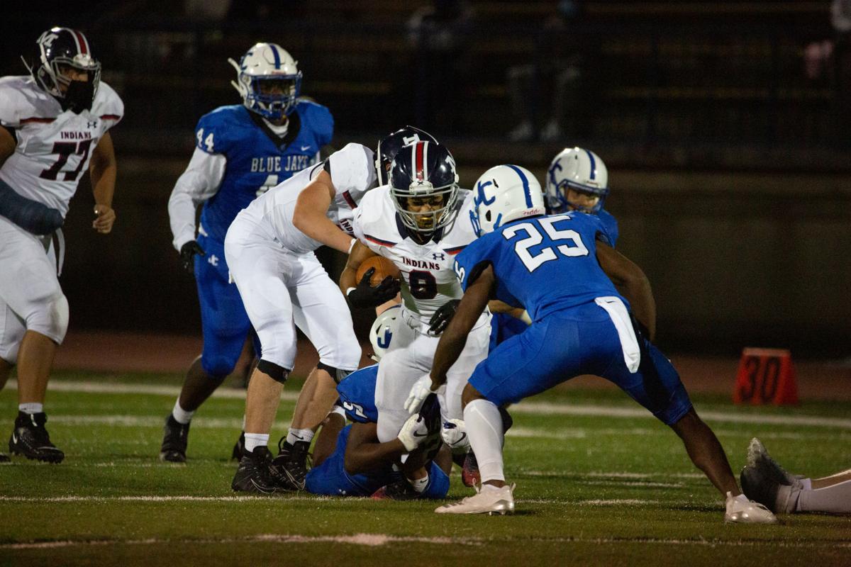 Running back Vincent Smith, junior, is grabbed by the knees and brought to a stop. Manhattan High Indians went head to head against the Junction City Bluejays on Friday night at Al Simpler Stadium with a final score of Junction City 36, Manhattan 29.