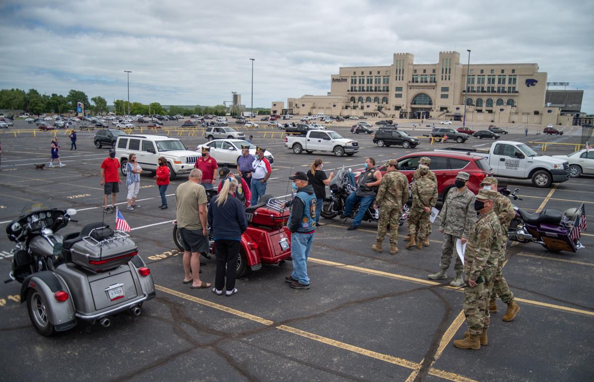 The National GuardÕs 190th Medical Group, members of the American Legion and community members of Manhattan gather in the Bill Snyder Family Stadium parking lot for the National GuardÕs 190th Air Refueling Wing flying over Ascension Via Christi Hospital on Tuesday.