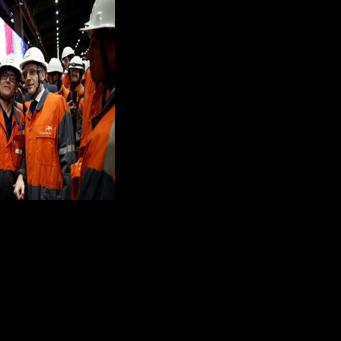 President Emmanuel Macron, right, taking selfies with employees at ArcelorMittal's Dunkirk site on Tuesday