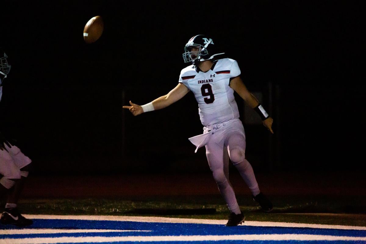 Quarterback Dayne Aschenbrenner, senior, flicks ball up in celebration after a touchdown. Manhattan High Indians went head to head against the Junction City Bluejays on Friday night at Al Simpler Stadium with a final score of Junction City 36, Manhattan 29.