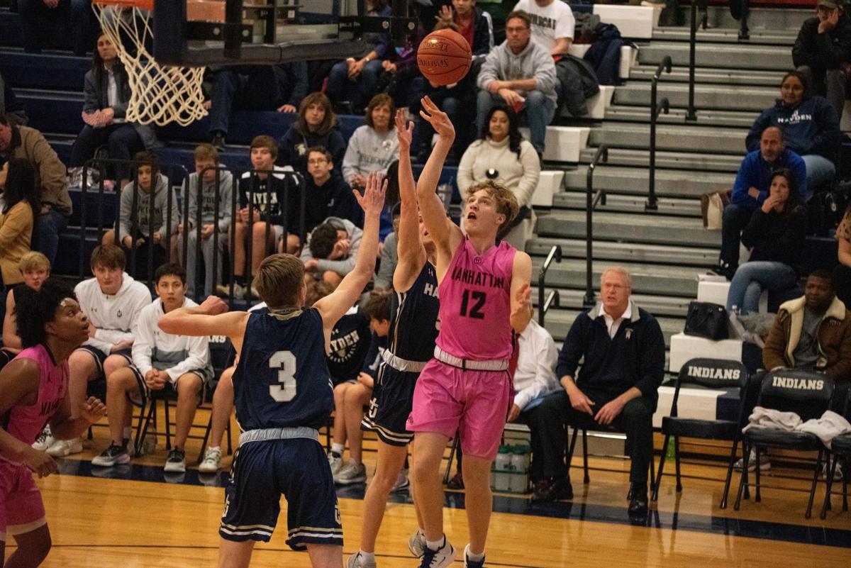 Owen Braxmeyer (12) attempts a shot while being guarded by Cade Pavilk (3).
