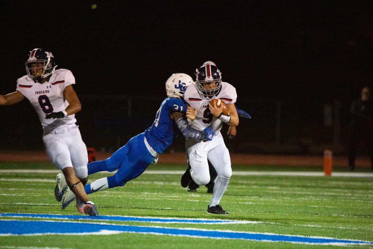 Junction City’s (number 31) tackles quarterback Dayne Aschenbrenner, senior, as he pushes forward. Manhattan High Indians went head to head against the Junction City Bluejays on Friday night at Al Simpler Stadium with a final score of Junction City 36, Manhattan 29.