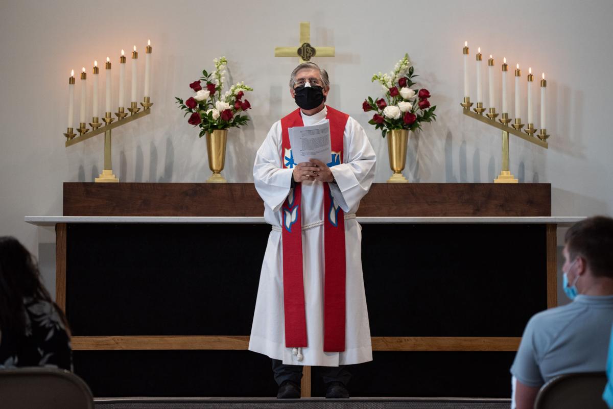 Pastor Michael Schmidt Sr. speaks from the altar during the service of dedication at St. LukeÕs Lutheran Church on Sunday. ÒPeace be to this house and to all who enter here in the name of the Father of the Son and of the Holy Spirit,Ó said Pastor Michael Schmidt Sr.