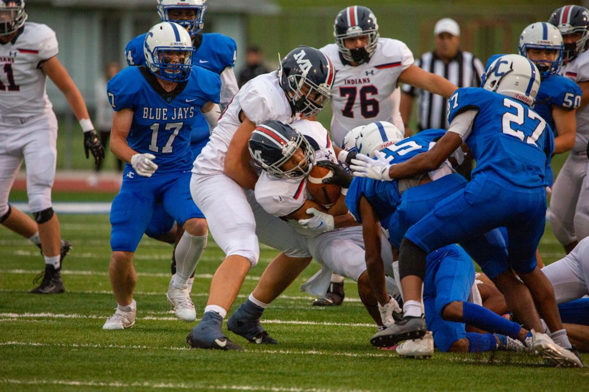 Running back Vincent Smith, junior, holds ball tight while falling. Manhattan High Indians went head to head against the Junction City Bluejays on Friday night at Al Simpler Stadium with a final score of Junction City 36, Manhattan 29.