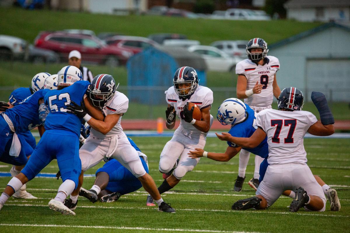 Running back Vincent Smith, junior, maneuvers through to find an opening. Manhattan High Indians went head to head against the Junction City Bluejays on Friday night at Al Simpler Stadium with a final score of Junction City 36, Manhattan 29.