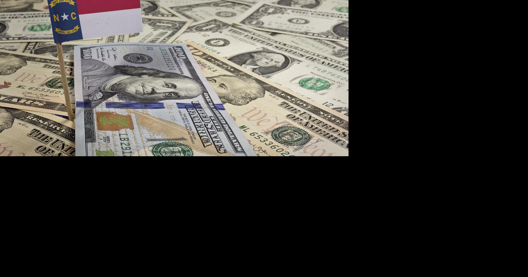 Flag of North Carolina sticking in various american banknotes.(s