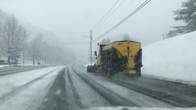 Snow plow clearing roads