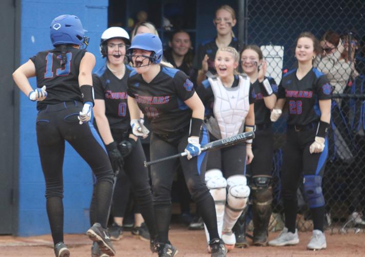 Lady Cougars celebrate Destiny Rutherford's inside-the-park home run.